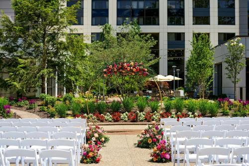 a row of white chairs in front of a building at Pittsburgh Airport Marriott in Robinson Township