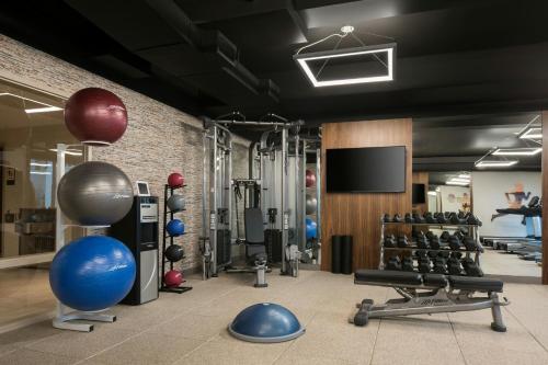 a gym with dumbbells and a flat screen tv at Residence Inn by Marriott Santa Barbara Goleta in Santa Barbara