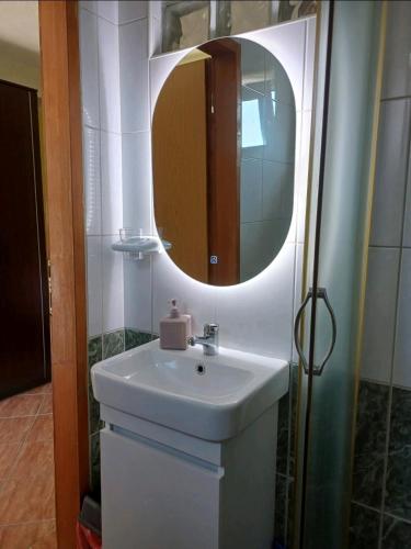 a bathroom with a sink and a mirror at Adriana Apartments in Herceg-Novi