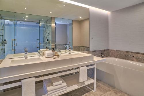 a bathroom with a tub and a sink and a bath tub at Hilton Buenos Aires in Buenos Aires