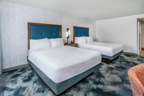 a hotel room with two beds and a couch at Hampton Inn & Suites Silverthorne in Silverthorne