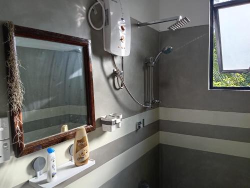a bathroom with a mirror and a sink at Vibe green villa in Unawatuna