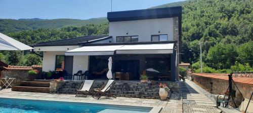 a villa with a swimming pool and a house at Villa Obednikovski in Ljubojno