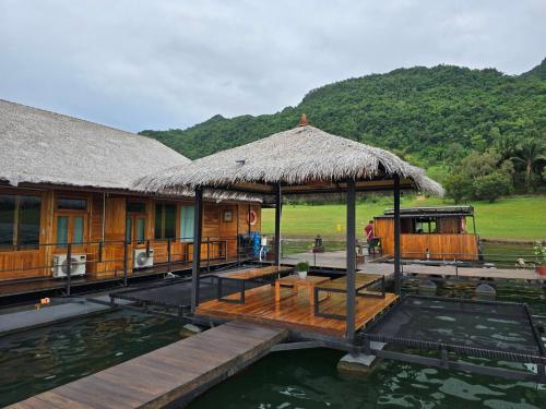 a house on the water with a dock at The Floating Lake House in Ban Pracham Mai Bon