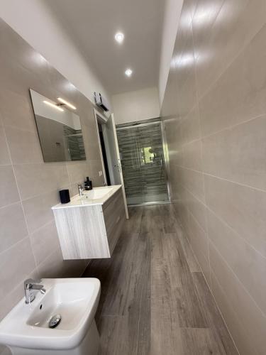 a bathroom with a sink and a toilet and a shower at Maison Aielli 112 in San Giuseppe Vesuviano