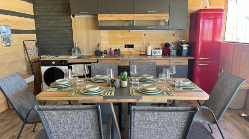 a kitchen with a wooden table with chairs and a tableasteryasteryasteryasteryastery at Бунгало woodwave in Chernomorets