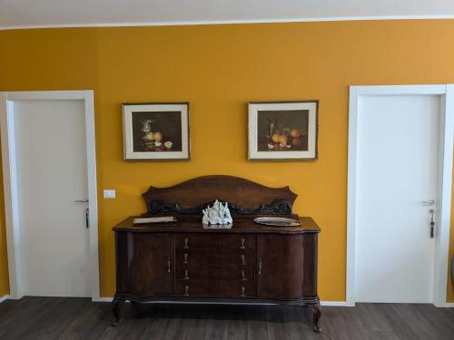 a room with a wooden table and two doors at An exclusive NEW apartment designed for modern living with timeless style in Bellano