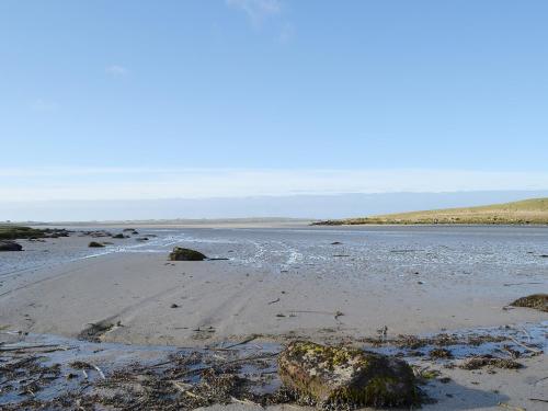 a beach with rocks and water on the shore at Creagan Na Mara in Paible