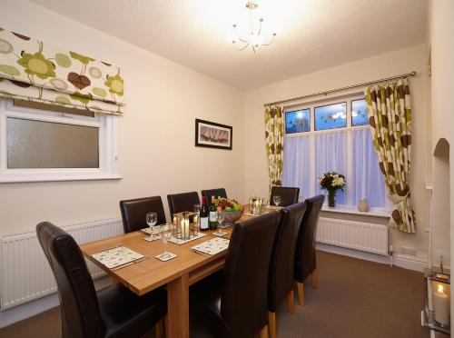 a dining room with a table and chairs and a window at The Old Stables in Filey