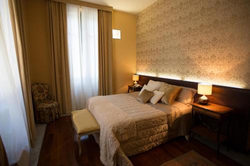 a hotel room with a bed and a window at Hotel Dei Pittori in Turin
