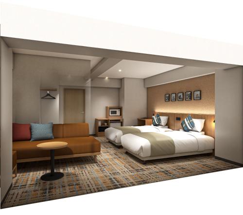 a hotel room with a bed and a couch at FLEXSTAY INN Higashi Jujo in Tokyo