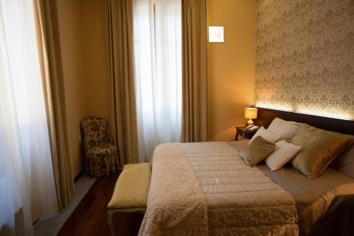 a hotel room with a bed and a window at Hotel Dei Pittori in Turin