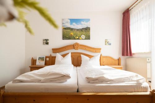 a bedroom with two beds with white sheets at Hotel-Gasthof Sondergeld in Hofbieber