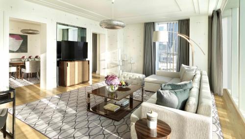 a living room with a couch and a table at Four Seasons Hotel Abu Dhabi at Al Maryah Island in Abu Dhabi