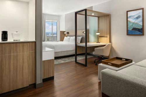 a hotel room with a bed and a desk at SpringHill Suites by Marriott Kalispell in Kalispell