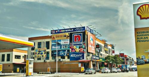 a busy city street with cars parked in front of buildings at Grand Kapar Hotel Kuala Selangor in Kuala Selangor