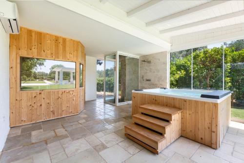 a large bathroom with a tub and windows at Il Trullo di Cimaglia by Perle di Puglia in Acquaviva delle Fonti