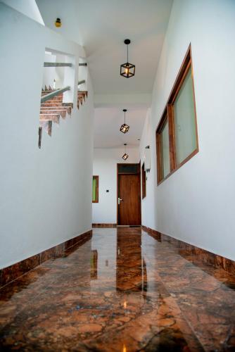 an empty hallway with white walls and a door at Grand Palace Hotel, Seeduwa in Seeduwa