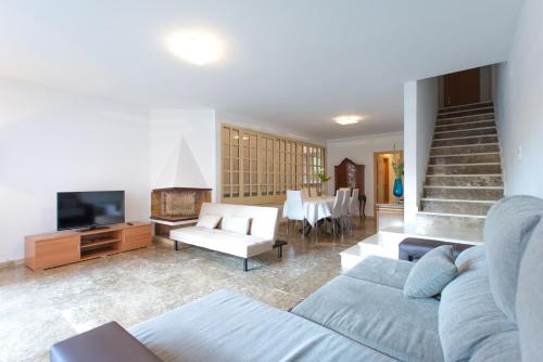 a living room with a couch and a tv at Holiday home Splendid Park Güell in Barcelona