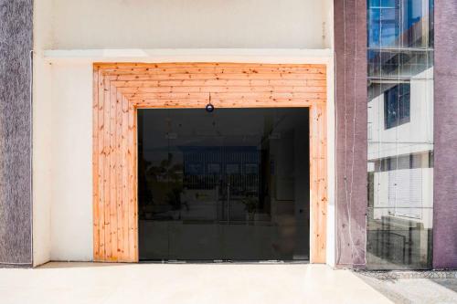 a large wooden door in a building at Hotel O Golapar Haldwani in Haldwāni
