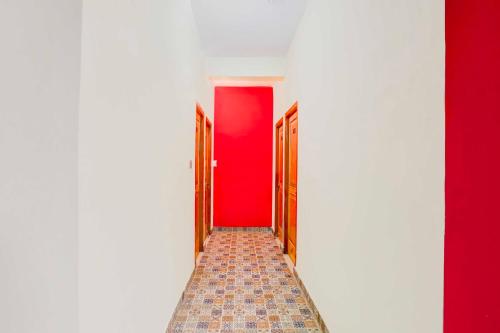 a hallway with red walls and a red door at Hotel O Bhowali Nainital Near Graphic Era Hill University in Nainital