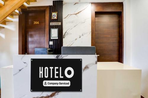 a hotel sign on a counter in a lobby at Hotel O Mall Road Nainital in Nainital
