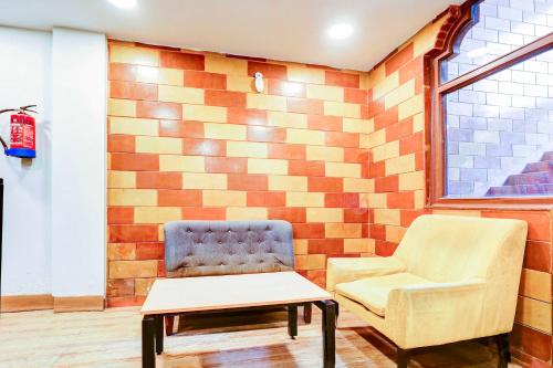 a living room with two chairs and a table at Hotel O Palam Near Railway Station in New Delhi