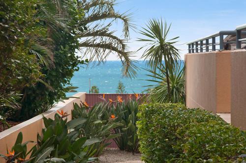 a view of the ocean from a house with plants at Alexandra on the Pacific in Mooloolaba