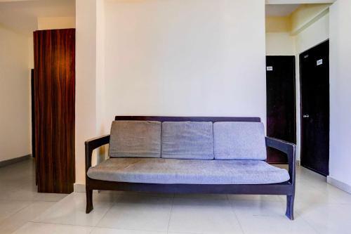 a blue couch sitting in a room at Hotel O Panjim Near Miramar Beach in Goa