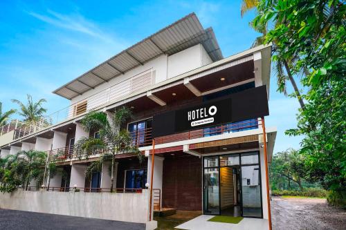 a building with a mieo sign on it at Hotel O Morjim in Morjim