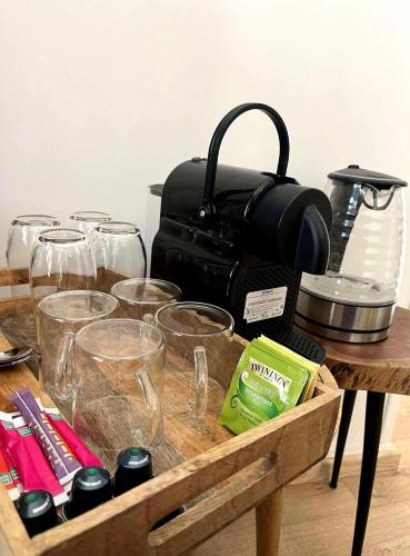 a wooden tray with glasses and a bag on a table at Maison Menadel in Yvetot