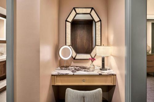 a dressing table with a mirror and a lamp at The Ritz-Carlton, Laguna Niguel in Dana Point