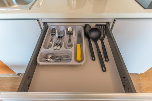 a drawer filled with utensils in a refrigerator at Jounieh Living - Residences by Local Host in Ed Dkârîne