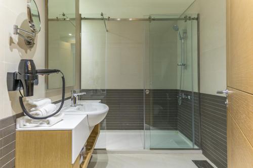 a bathroom with a sink and a shower at Jounieh Living - Residences by Local Host in Ed Dkârîne