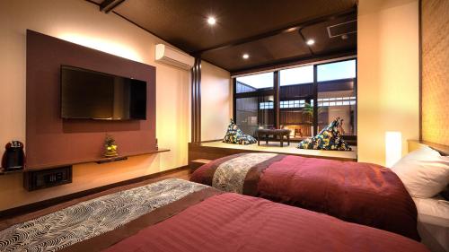 a bedroom with a bed and a large window at Kiyonoya in Asakura