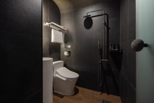 a bathroom with a toilet and a shower at Cave Ryokan Hotel by Aank Sungshin Women's University in Seoul