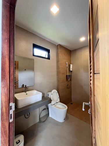 a bathroom with a white toilet and a sink at Pontakorn Villa 1 in Ko Phangan