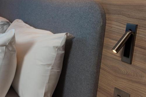 a bed with white pillows in a hotel room at Holiday Inn Express - Glasgow Airport by IHG in Paisley