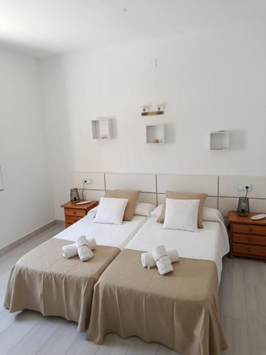two beds in a room with towels on them at Casa S Estany in La Savina