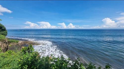 a view of the ocean on a sunny day at Melaya Cabanas in Candikesuma