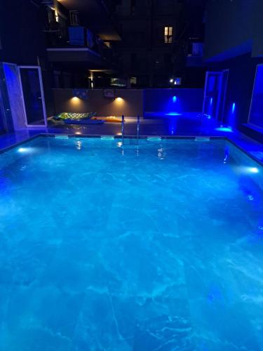 a large swimming pool at night with blue lights at Premium Studio Family I in Paralia Katerinis