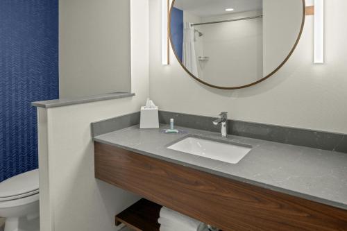 a bathroom with a sink and a mirror at Fairfield by Marriott Inn & Suites Winters Davis in Winters