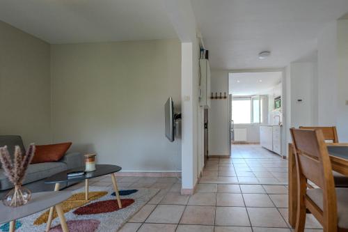 a living room with a couch and a table at Le Fernand - Campus - Parking in Saint-Martin-dʼHères