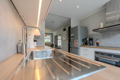 a kitchen with a stainless steel sink in a kitchen at Le Fernand - Campus - Parking in Saint-Martin-dʼHères