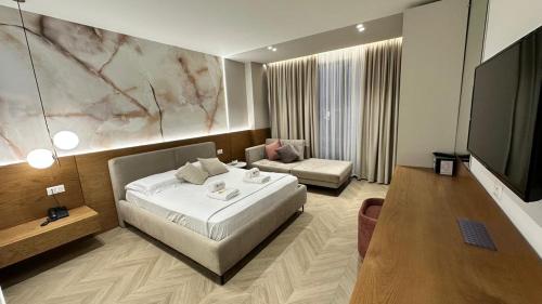 a hotel room with a bed and a couch at Memai Suites in Ksamil