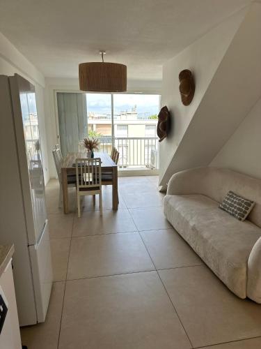 a living room with a couch and a table at Perle Rare vue Mer et marais salants sur Giens à Hyeres in Hyères