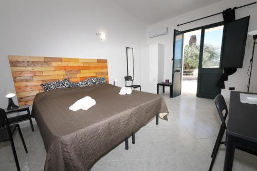 Ένα ή περισσότερα κρεβάτια σε δωμάτιο στο Fiumara Val Di Noto Country Rooms