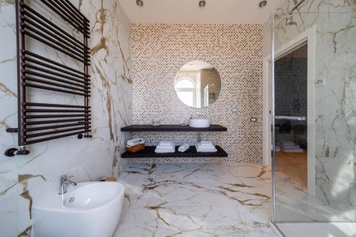 a bathroom with a sink and a mirror at Villa Giada Luxury Boutique Hotel in Civitavecchia