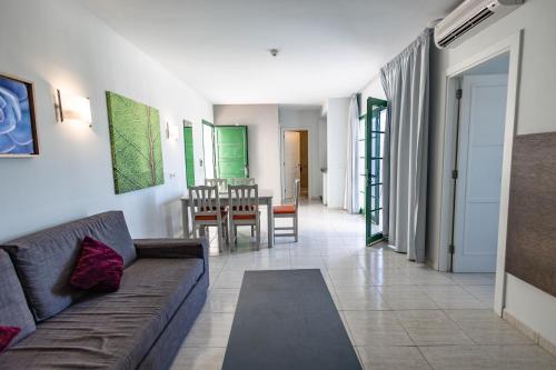 a living room with a couch and a table at Caybeach Sun in Playa Blanca