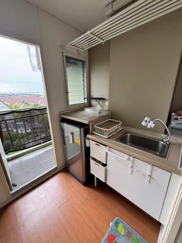 a small kitchen with a sink and a window at Condo located 5 minutes away from Suvarnabhumi Airport by taxi for cooking, short-term rental, and long-term rental in Sathani Lat Krabang